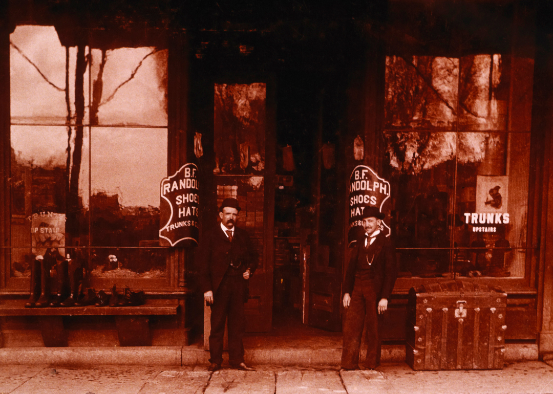Two men standing in front of variety store