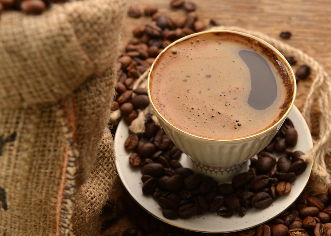 Coffee beans and cup of black coffee.