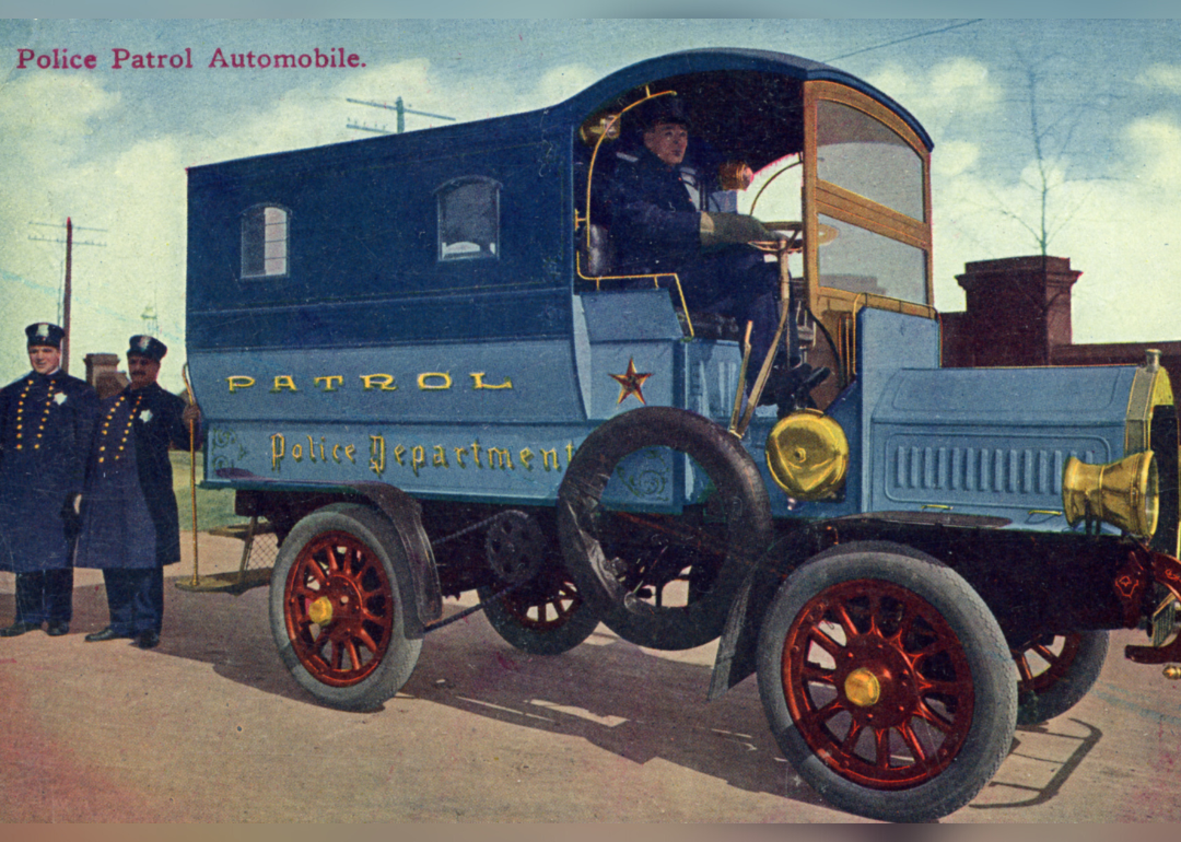 Lithographic postcard showing policemen in and around their patrol wagon.