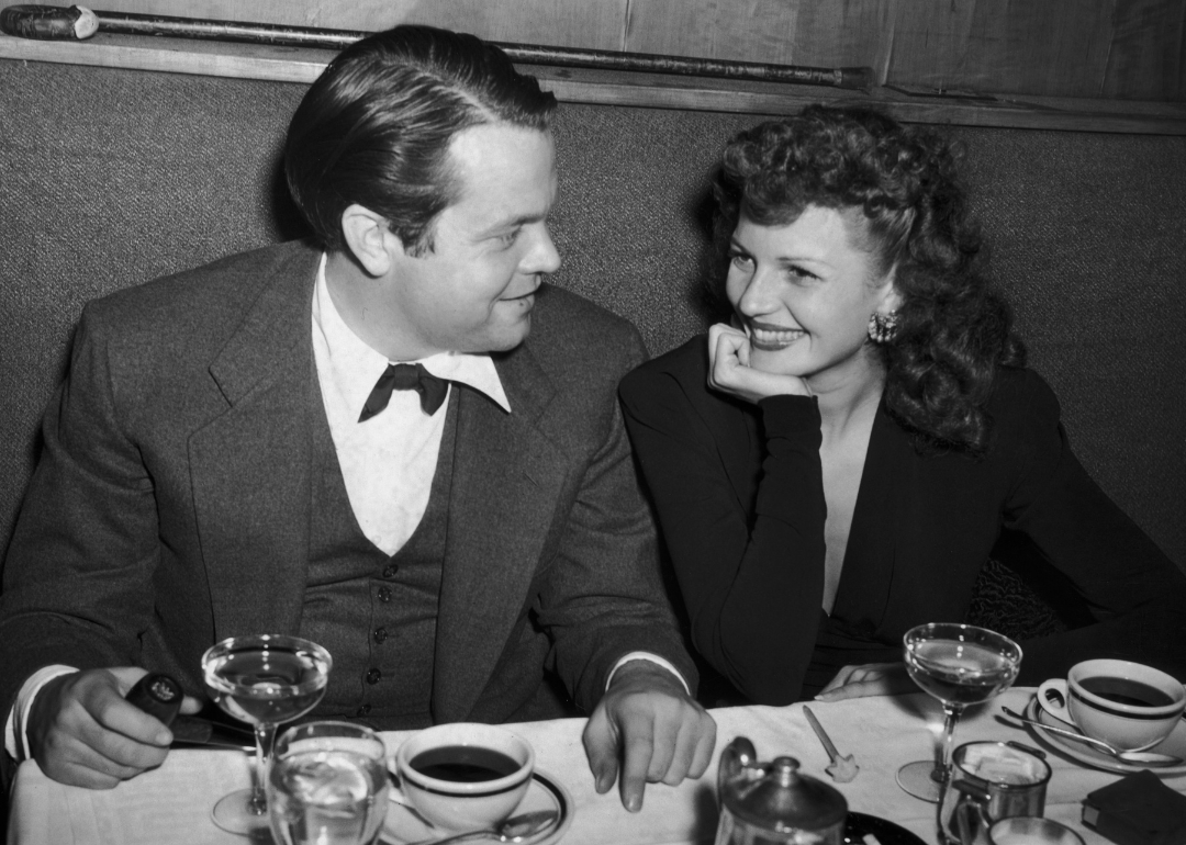 Orson Welles and Rita Hayworth photographed at a restaurant.