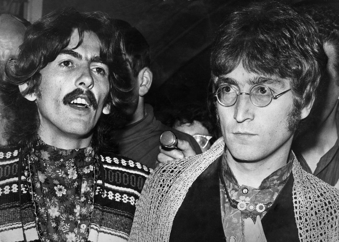 George Harrison and John Lennon of The Beatles talking to the press and media in 1967.