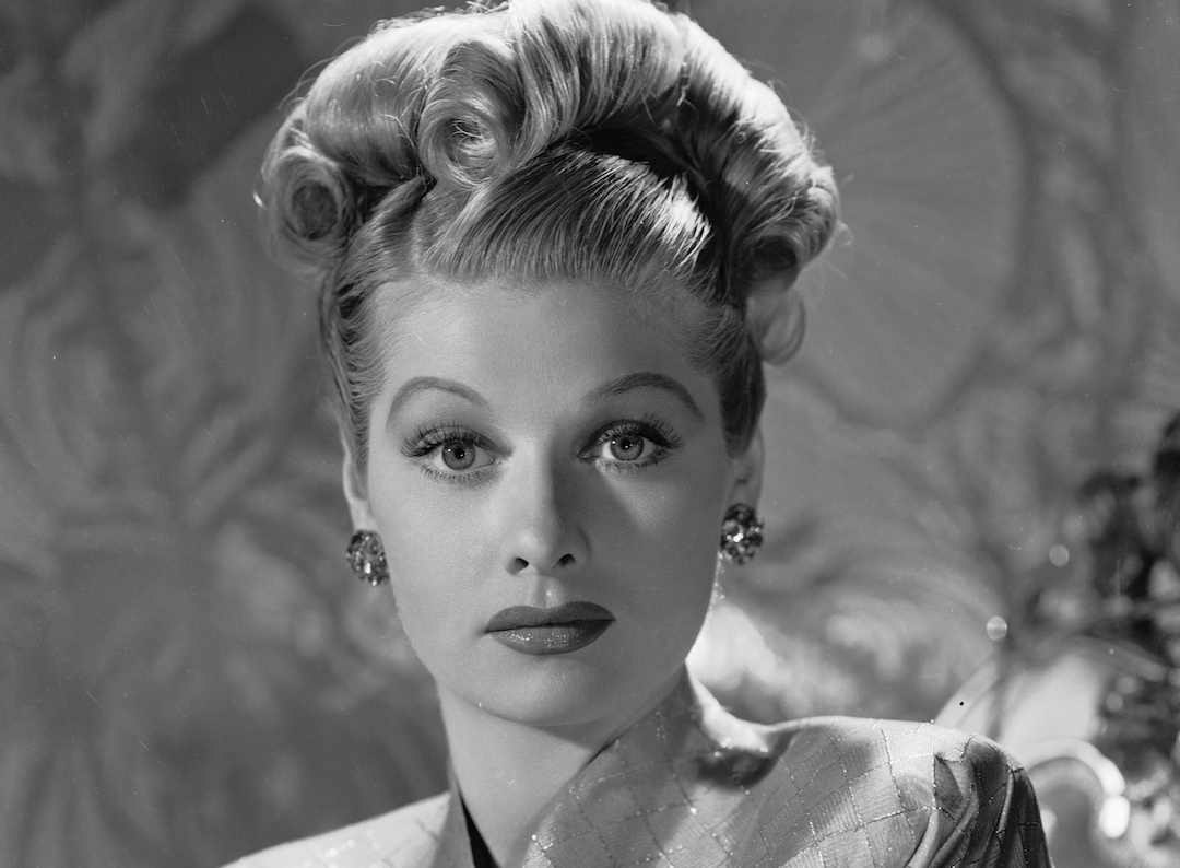 Actress Lucille Ball wearing an elaborate rolled hairstyle.
