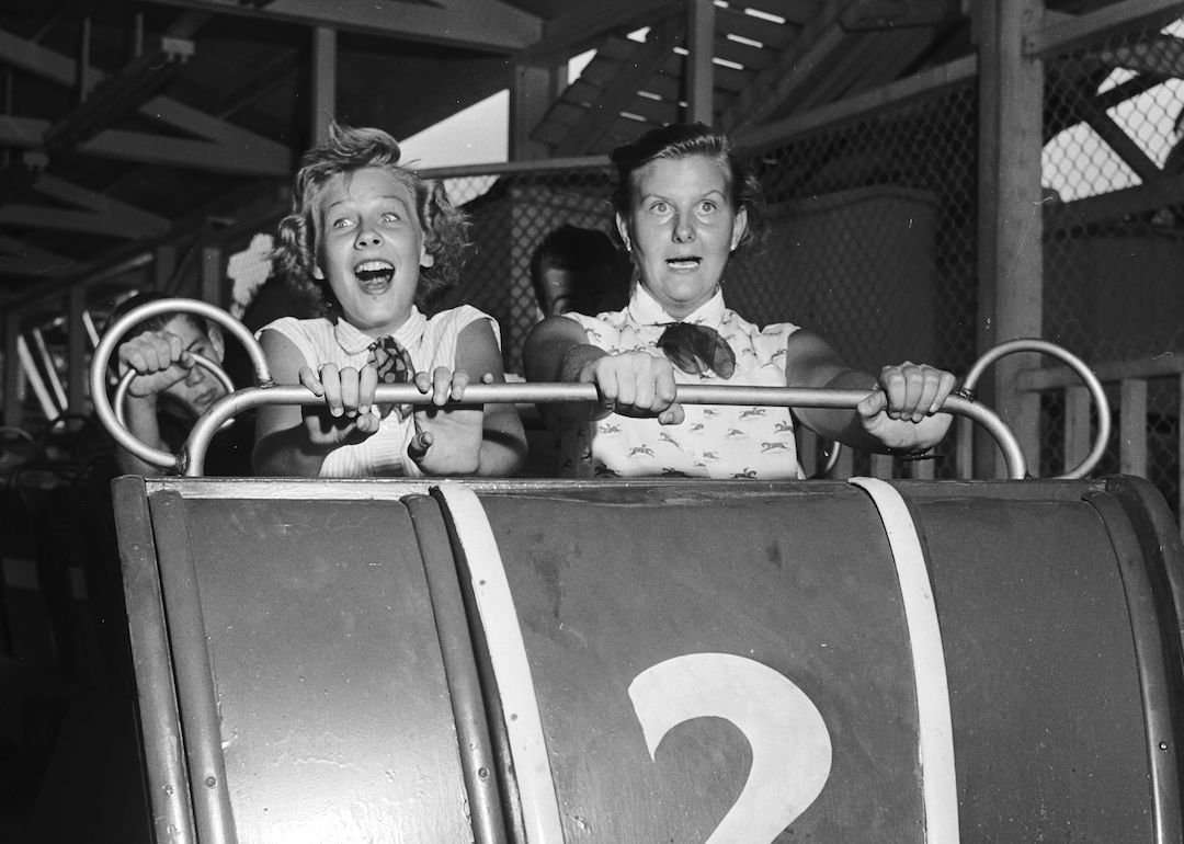Expressions of fear and excitement on the faces of riders on the roller coaster at Palisades Park, New Jersey in 1955.