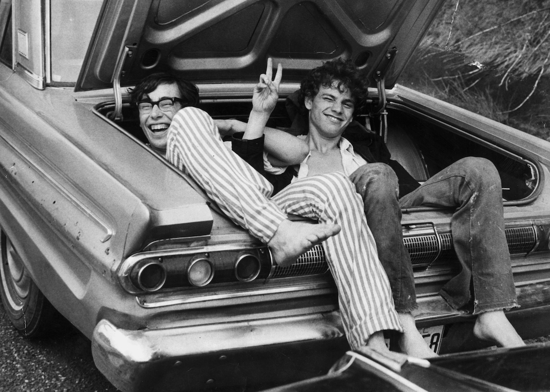 Two young men in the boot of a car after hitching a lift home from the Woodstock Music and Arts Fair in August 1969.