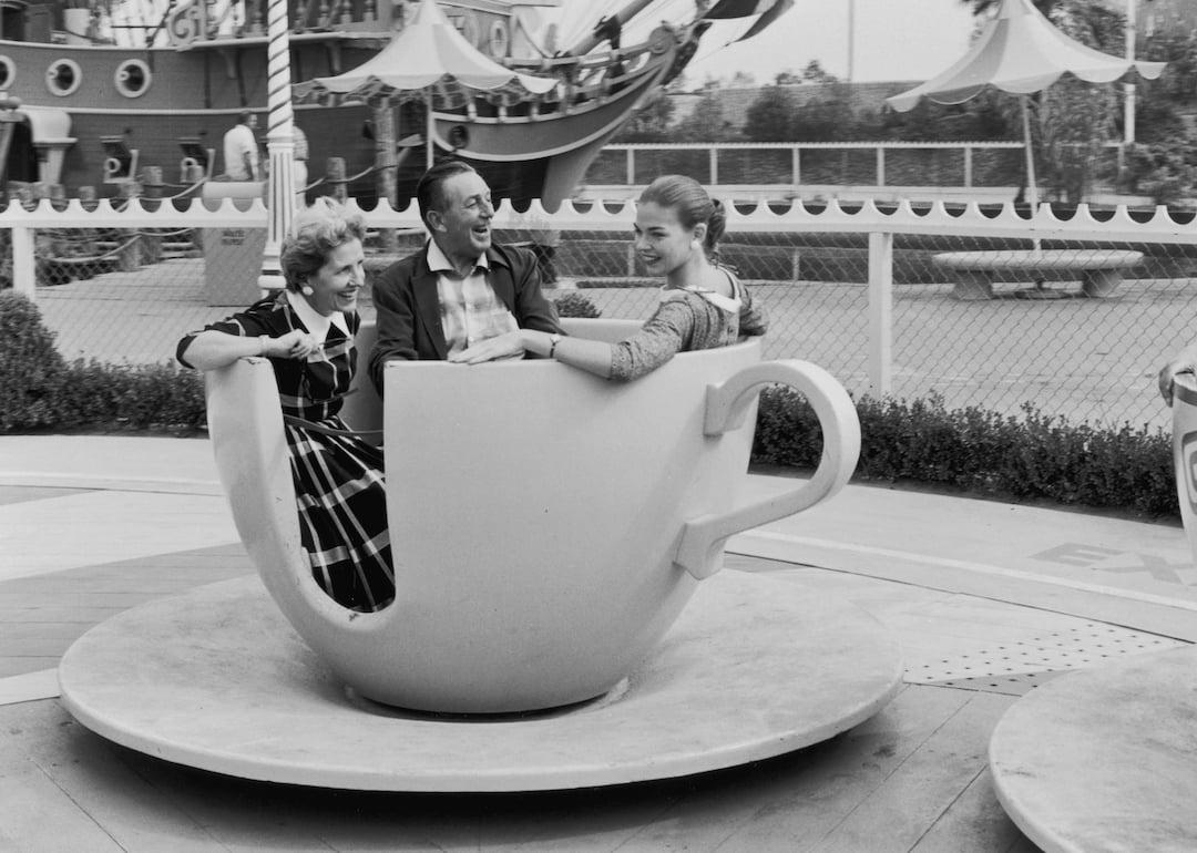 American animator and producer Walt Disney with his wife, Lillian, and their daughter, Diane, ride a spinning tea cup at Disneyland, shortly after its opening, Anaheim, California, in 1955.