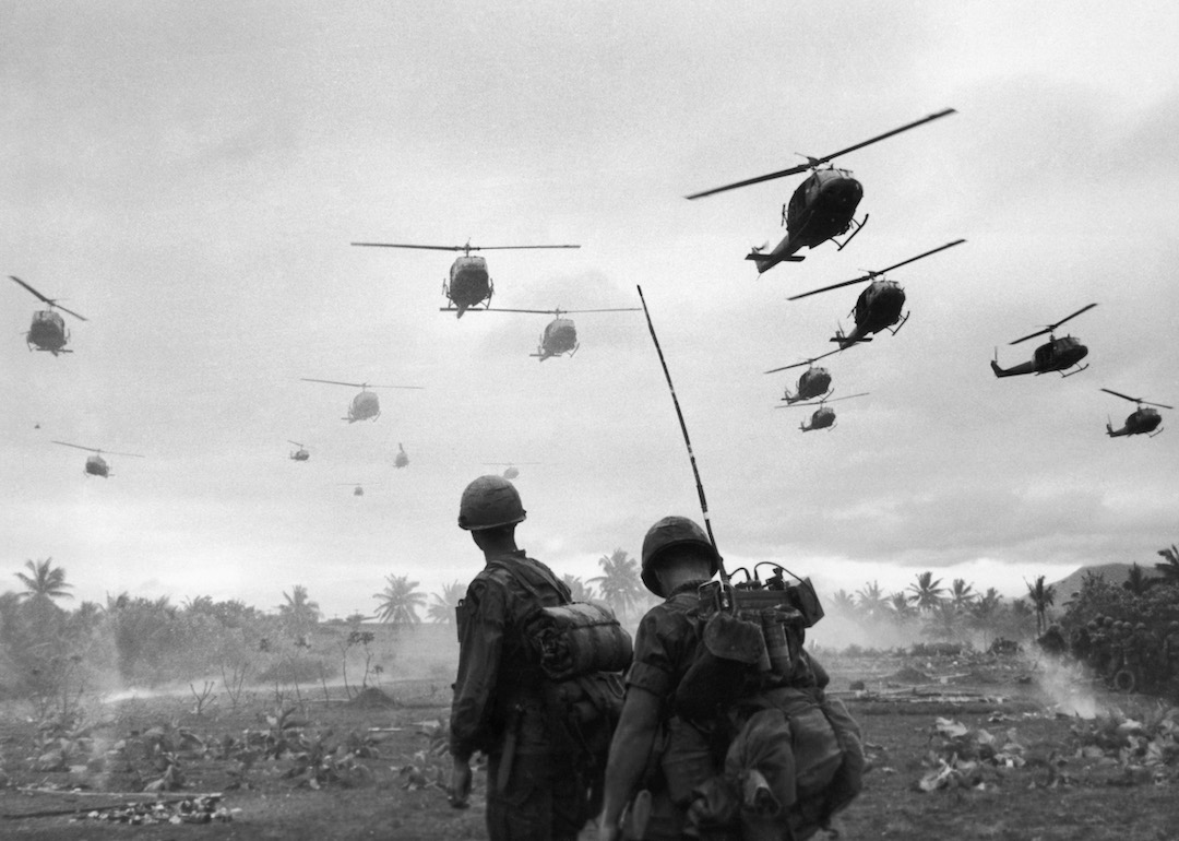 Combat helicopters of the 1st Air Cavalry Division fly over an RTO and his commander on an isolated landing zone during Operation Pershing during the Vietnam War.
