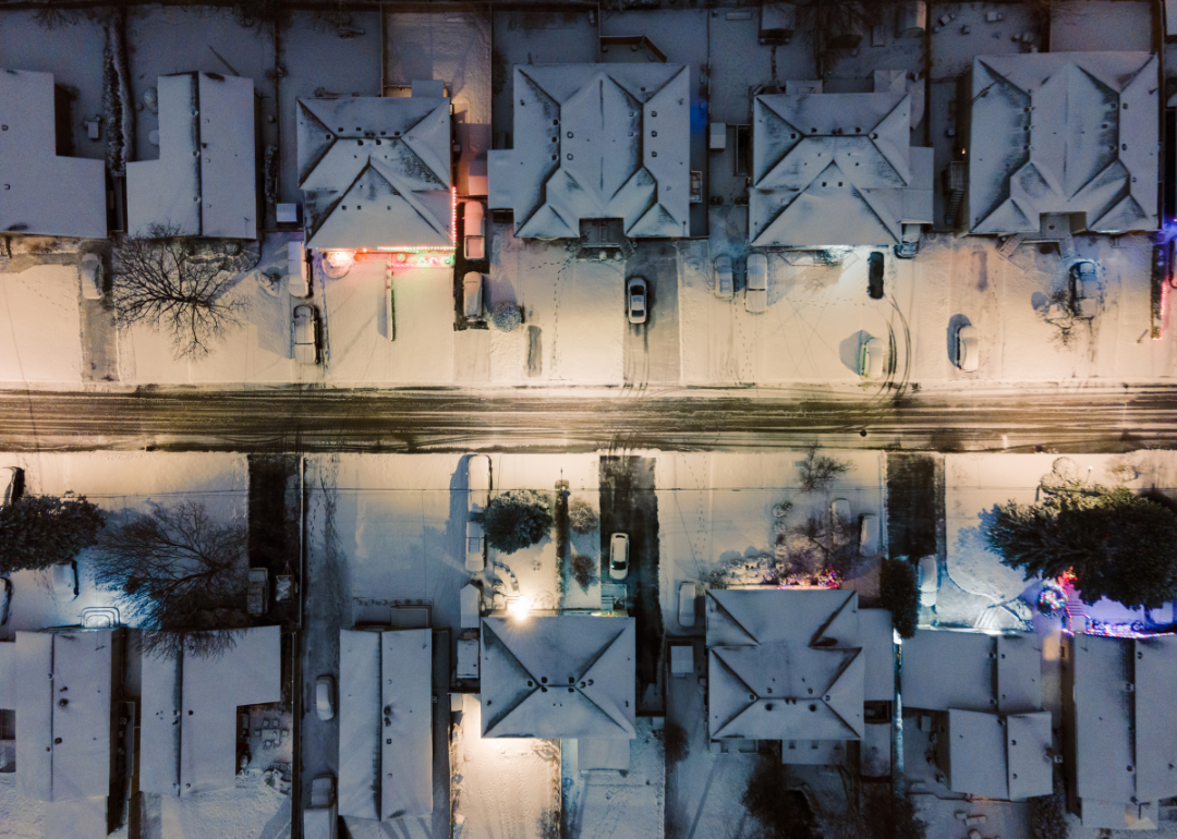 Houses on a suburban street covered in snow.