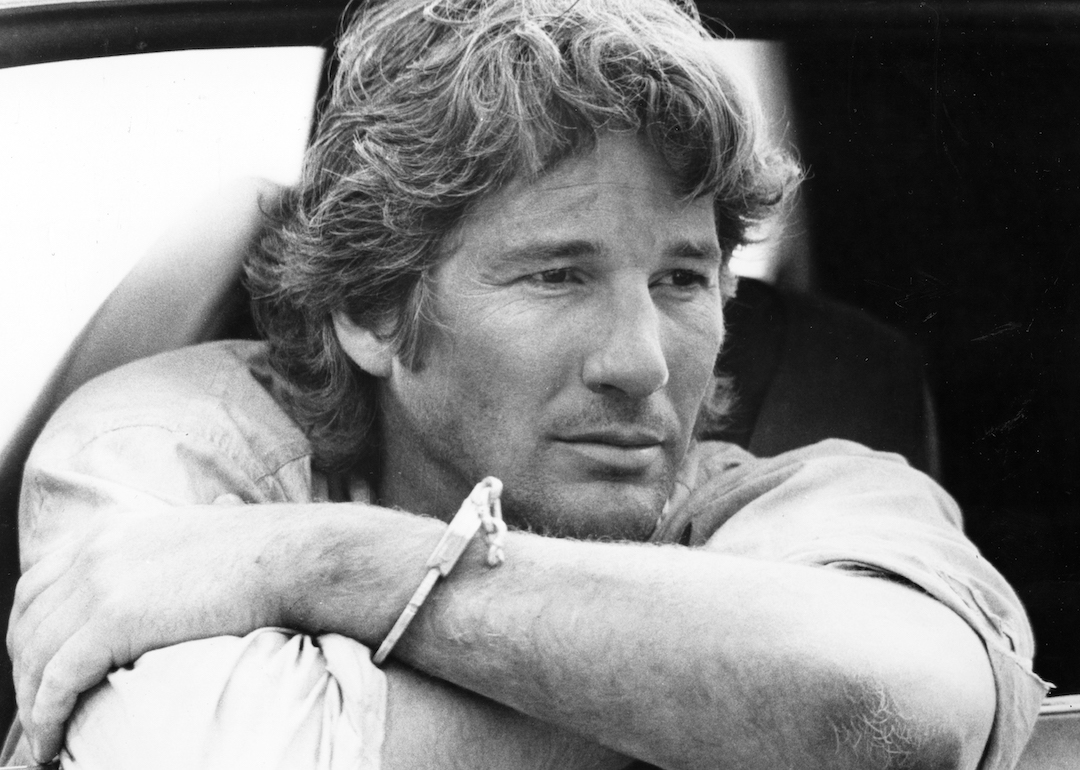 Richard Gere leans out the side of a car in the movie 'No Mercy' in 1986.