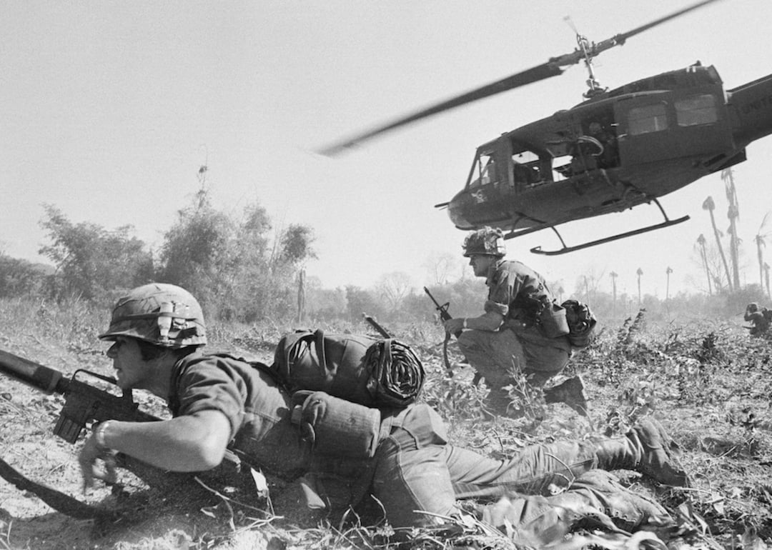U.S. troopers get down low after being dropped by helicopter in Thu Xuan during Operation Eagle's Claw in Feb. 1966 during the Vietnam War.