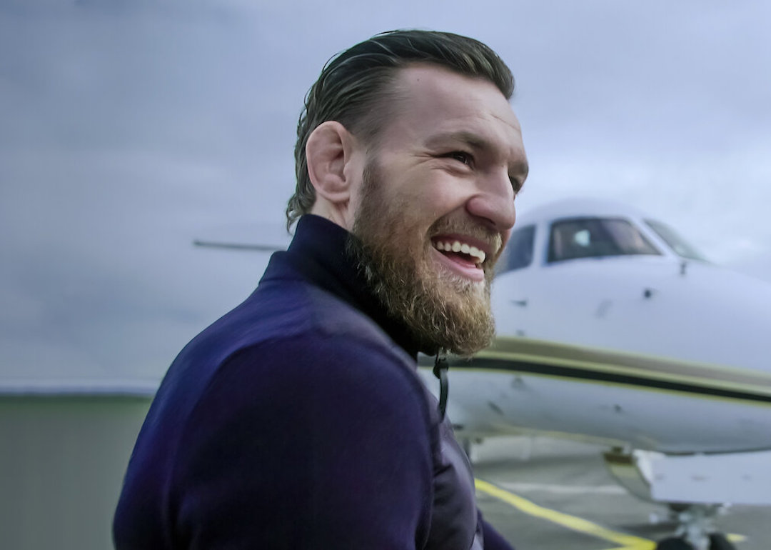 Conor McGregor smiles before boarding a plane in a scene from the Netflix docuseries 'McGregor Forever.'