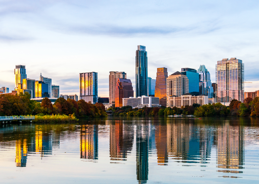 Downtown Austin, Texas skyline reflecting on lake.
