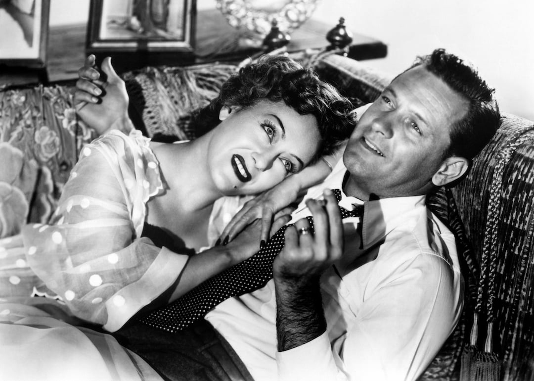 Actors Gloria Swanson and William Holden on a couch in the movie 'Sunset Boulevard.'