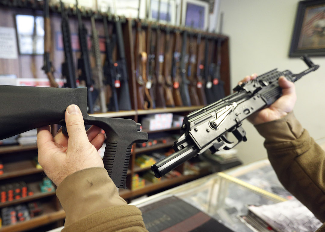 A bump stock device (left) that fits on a semi-automatic rifle to increase the firing speed, making it similar to a fully automatic rifle, is shown next to a AK-47 semi-automatic rifle (right) at a gun store on October 5, 2017 in Salt Lake City, Utah.