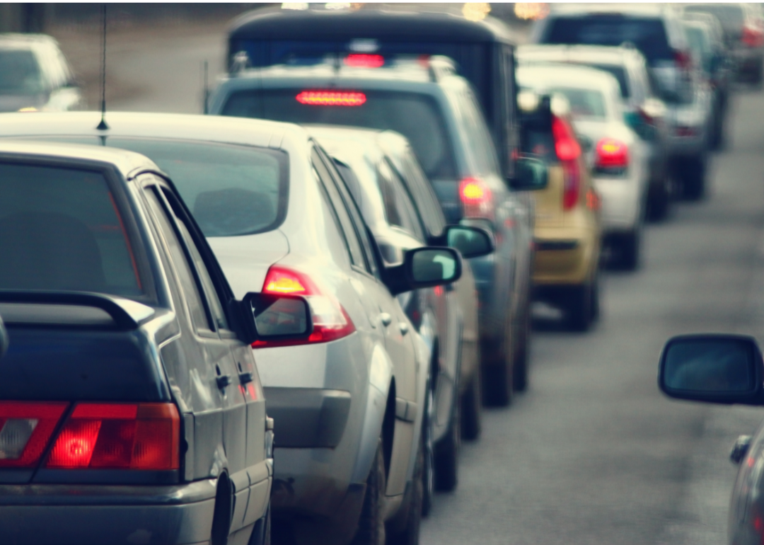 Cars sit in traffic on a highway.