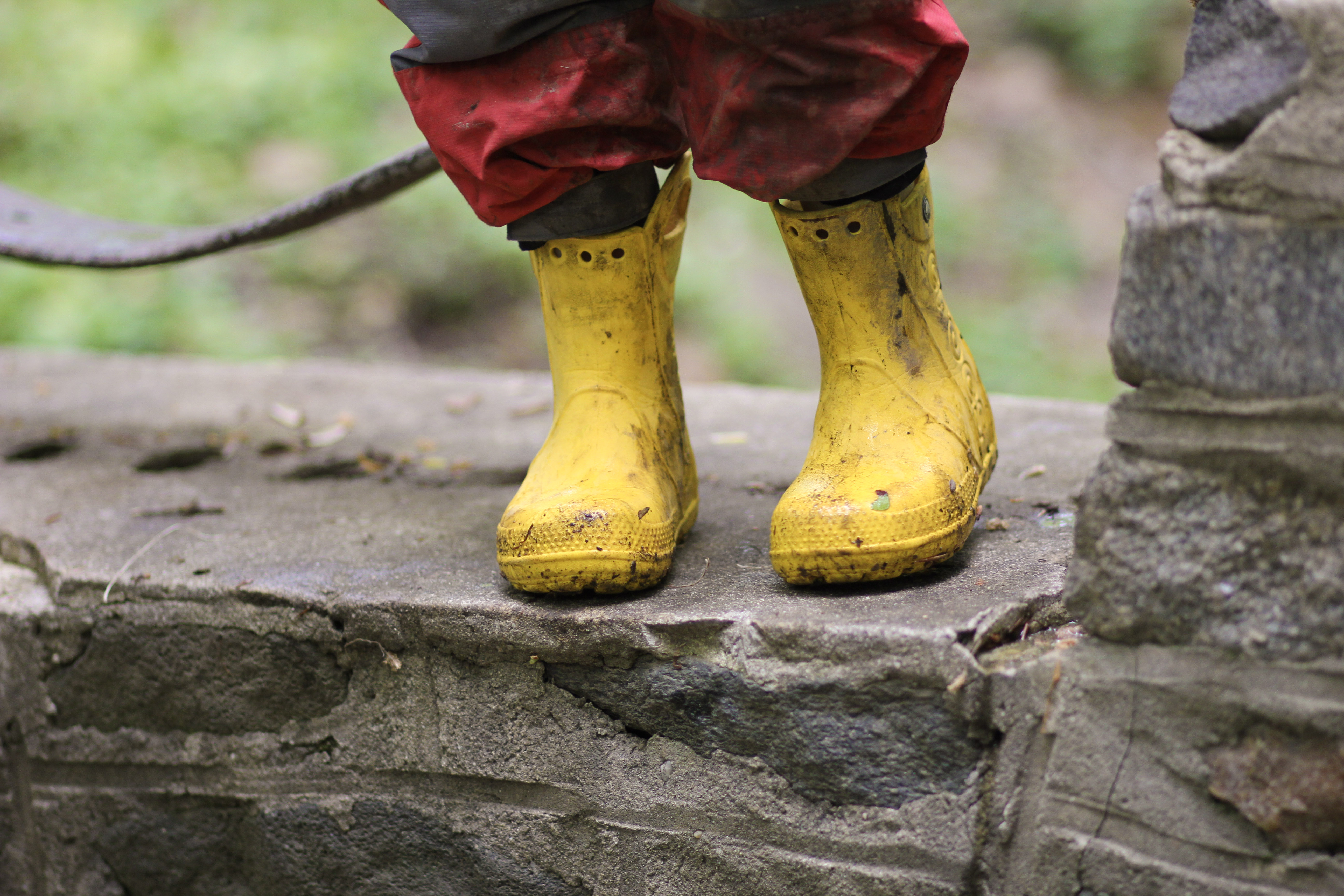  A child's feet in yellow rain boots.