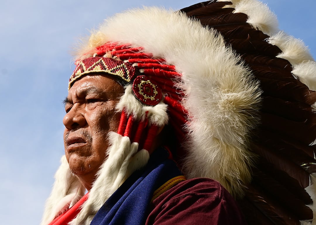 Northern Cheyenne tribal chief Anthony Spottedwolf listens to Cheyenne and Arapaho tribal members perform in a drum circle as they play a traditional flag and memorial song during a gathering at the Sand Creek Massacre National Historic site on October 5, 2022.