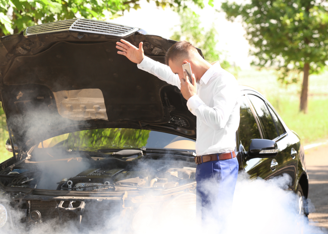 A man calls for help as his overheated car billows smoke.