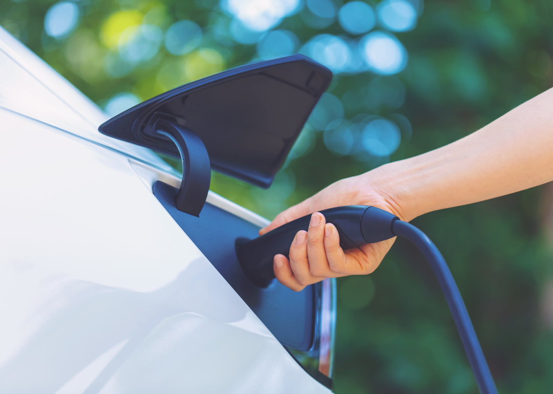 A person charging electric vehicle.