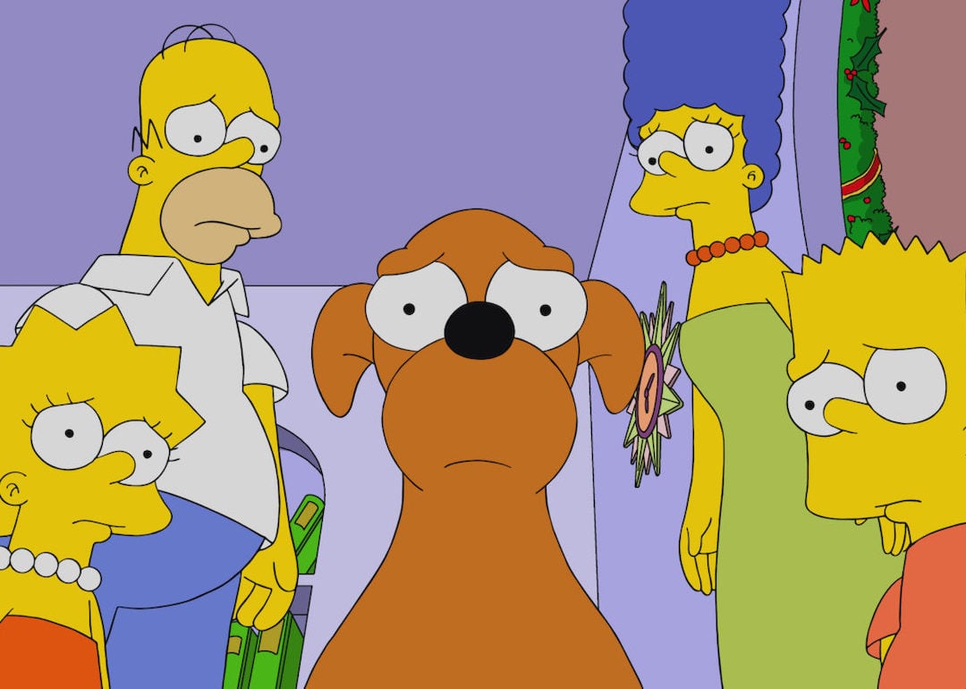 Lisa, Homer, Marge, and Bart Simpson with their dog, Santa's Little Helper, on 'The Simpsons.'