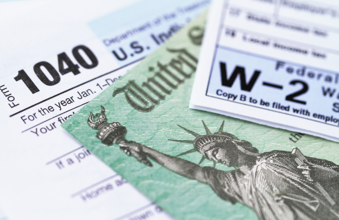 IRS tax forms with a tax refund check.