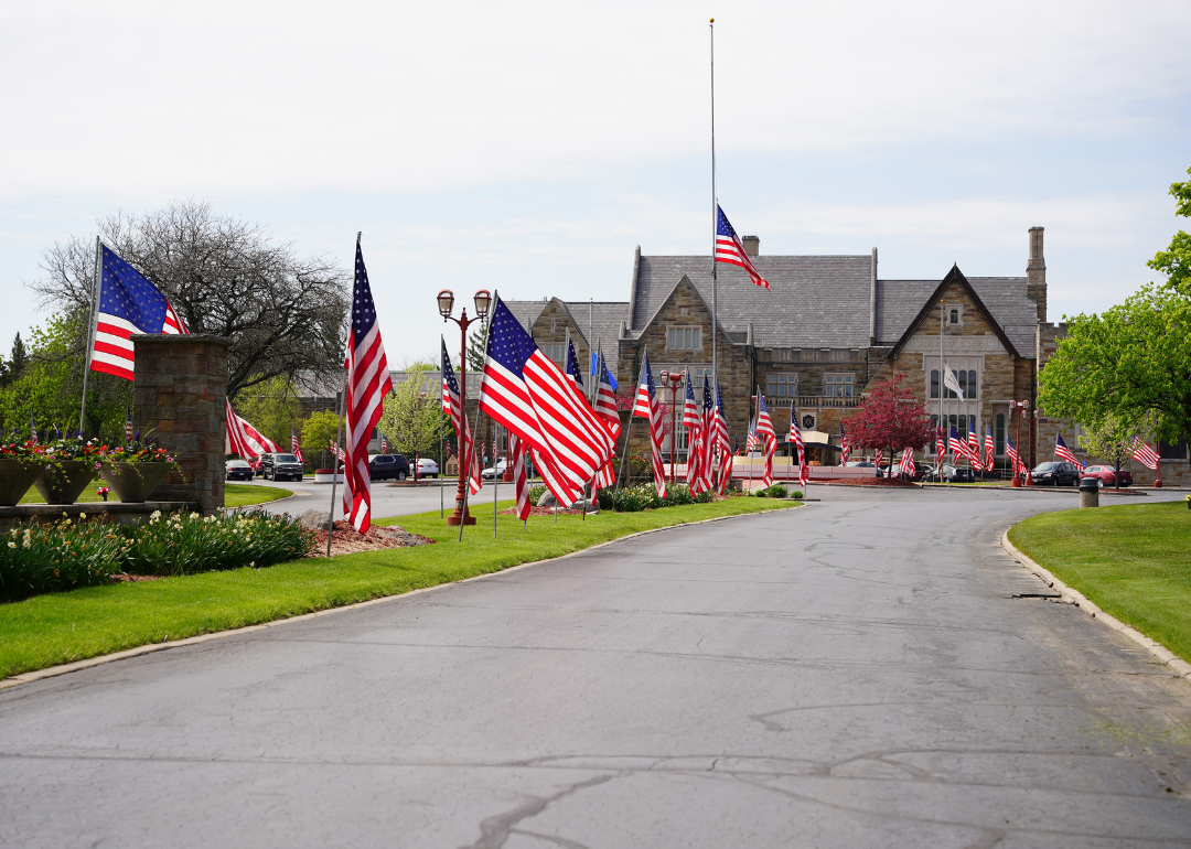 Florida neighbors give flag-waving surprise to young man with