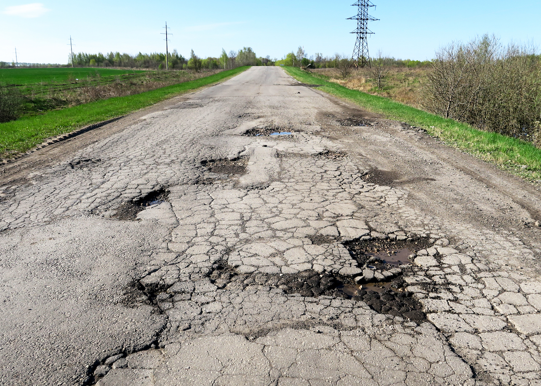 Highway filled with potholes and cracks.