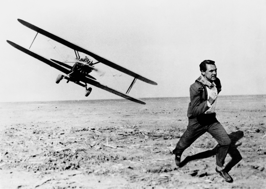 Actor Cary Grant (1904 - 1986) is pursued across a cornfield by a cropduster in the Hitchcock film 'North by Northwest', 1959. 