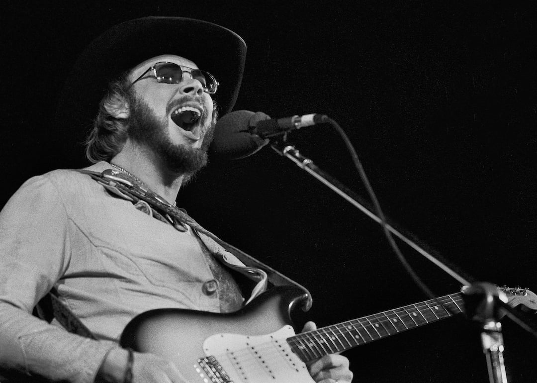 Country musician Hank Williams Jr. plays guitar as he performs onstage at an unspecified venue, Oakbrook, Illinois on Nov. 27, 1977. 