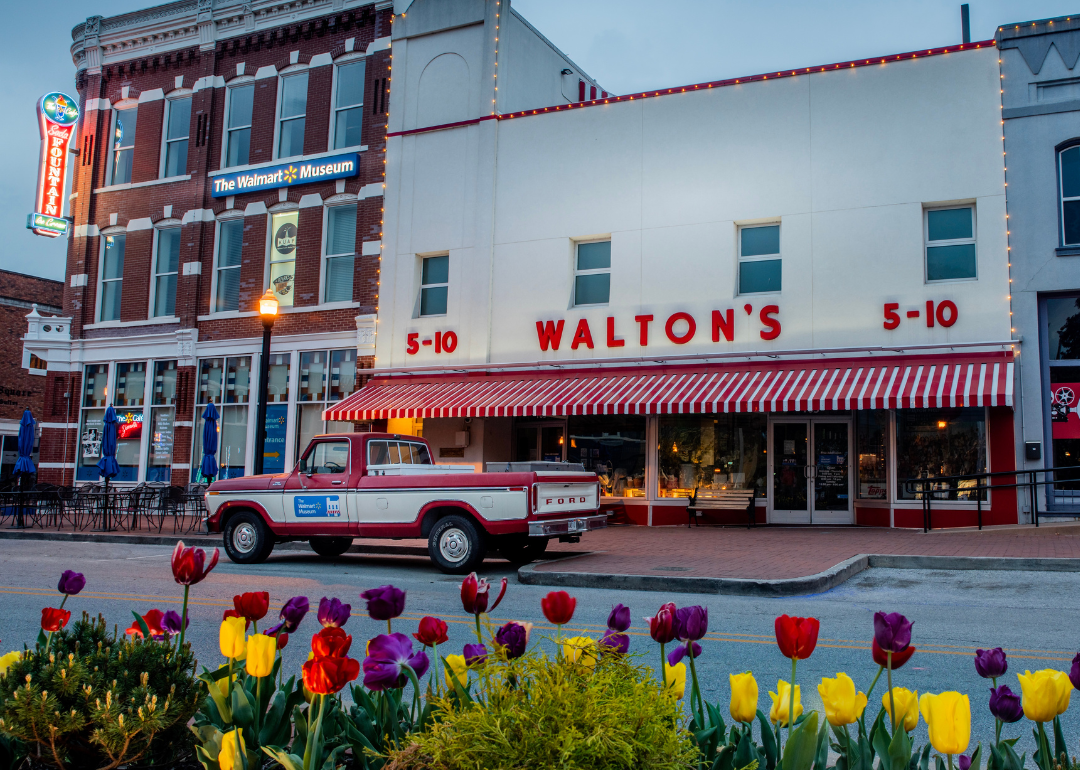 Old red and white ford truck that belonged to Sam Walton parked in front of first Walmart store which now serves as a corporate museum near the Arkansas headquarters in Bentonville