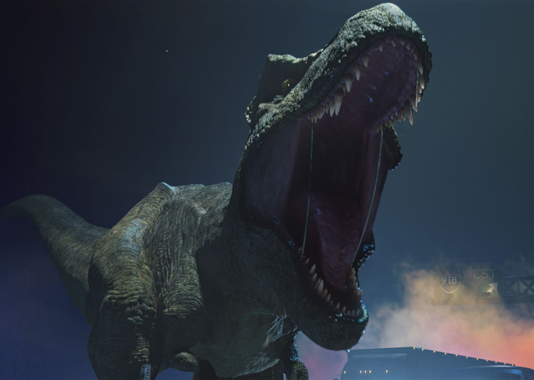 An animated T-rex roars on a US freeway in a scene from 'Jurassic World: Chaos Theory' 