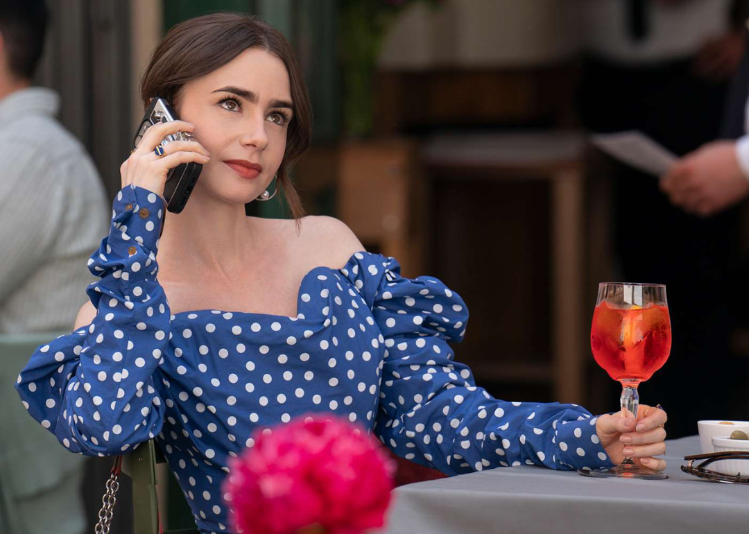 Lily Collins holding a phone to her ear in a scene from season4 of 'Emily in Paris'