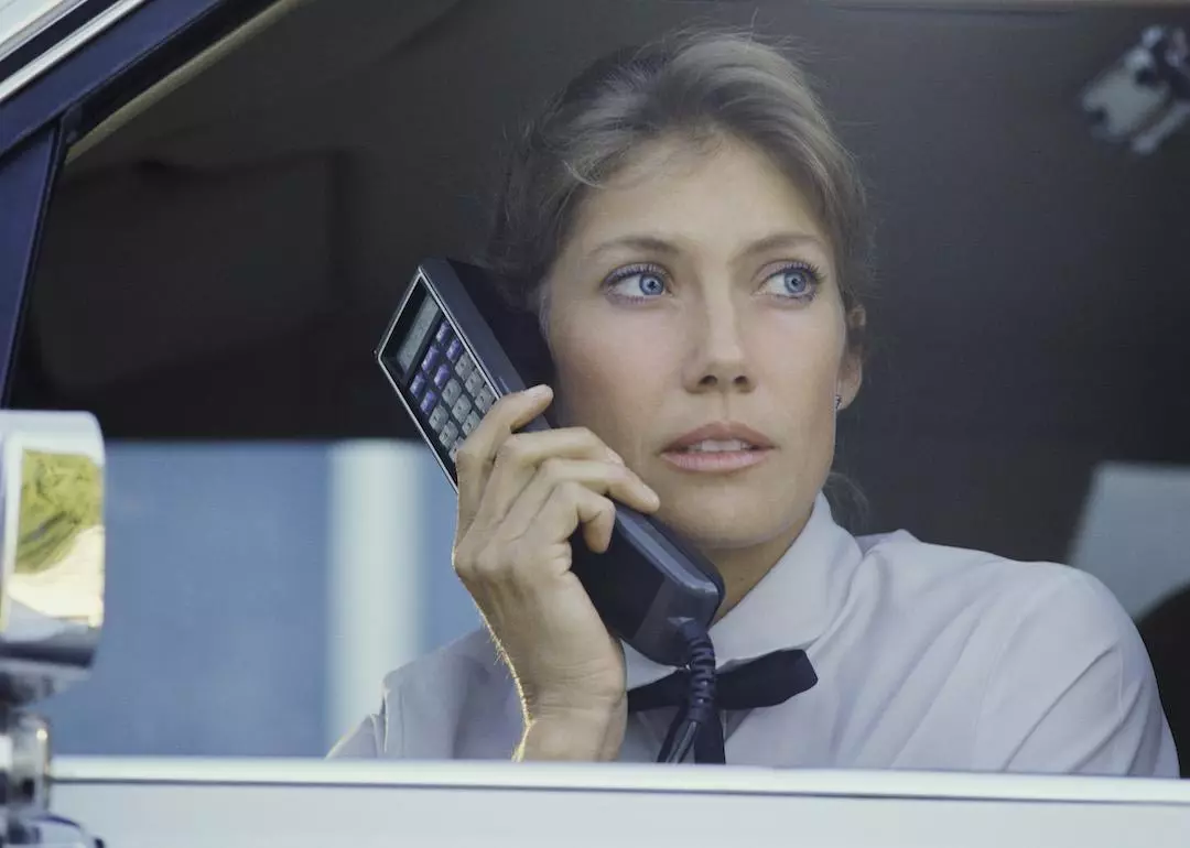 Woman talking on a large car phone