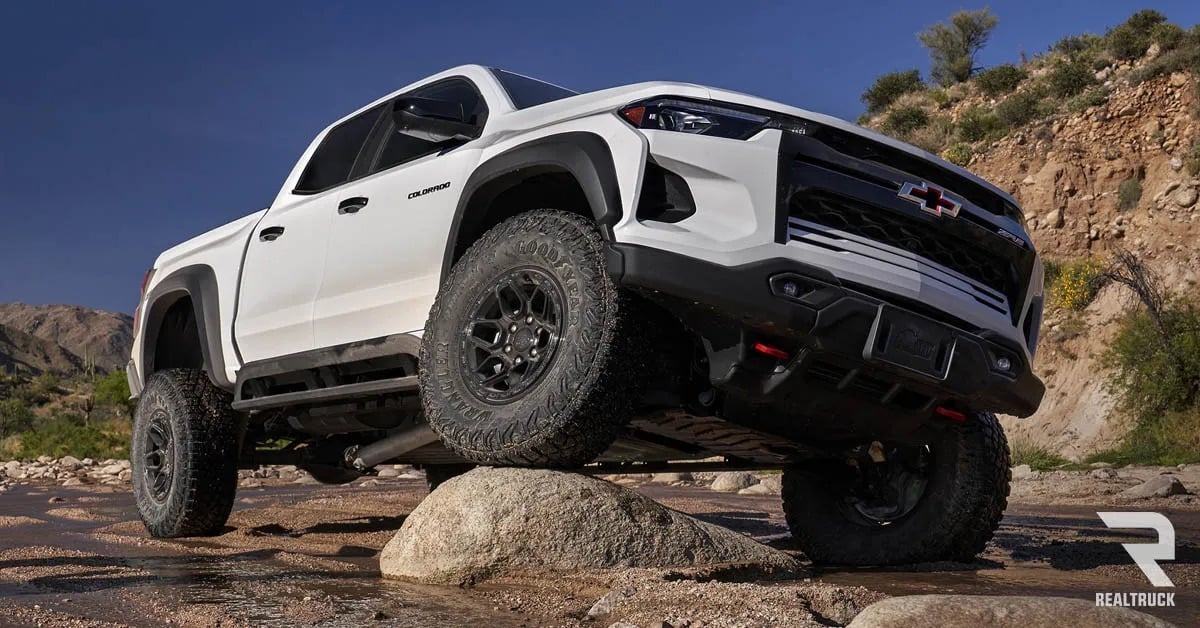 A white Chevy Colorado ZR2 displayed on rocky terrain.
