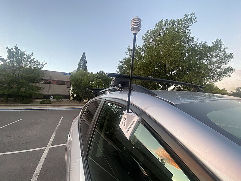 Heat mapping volunteers fit a snorkel-like sensor into their car windows, which gather temperature and humidity readings while driving their assigned routes.