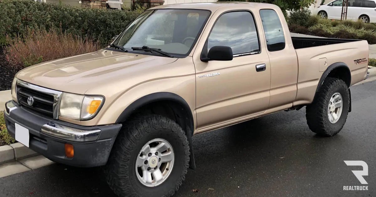 A beige 1998 Toyota Tacoma.