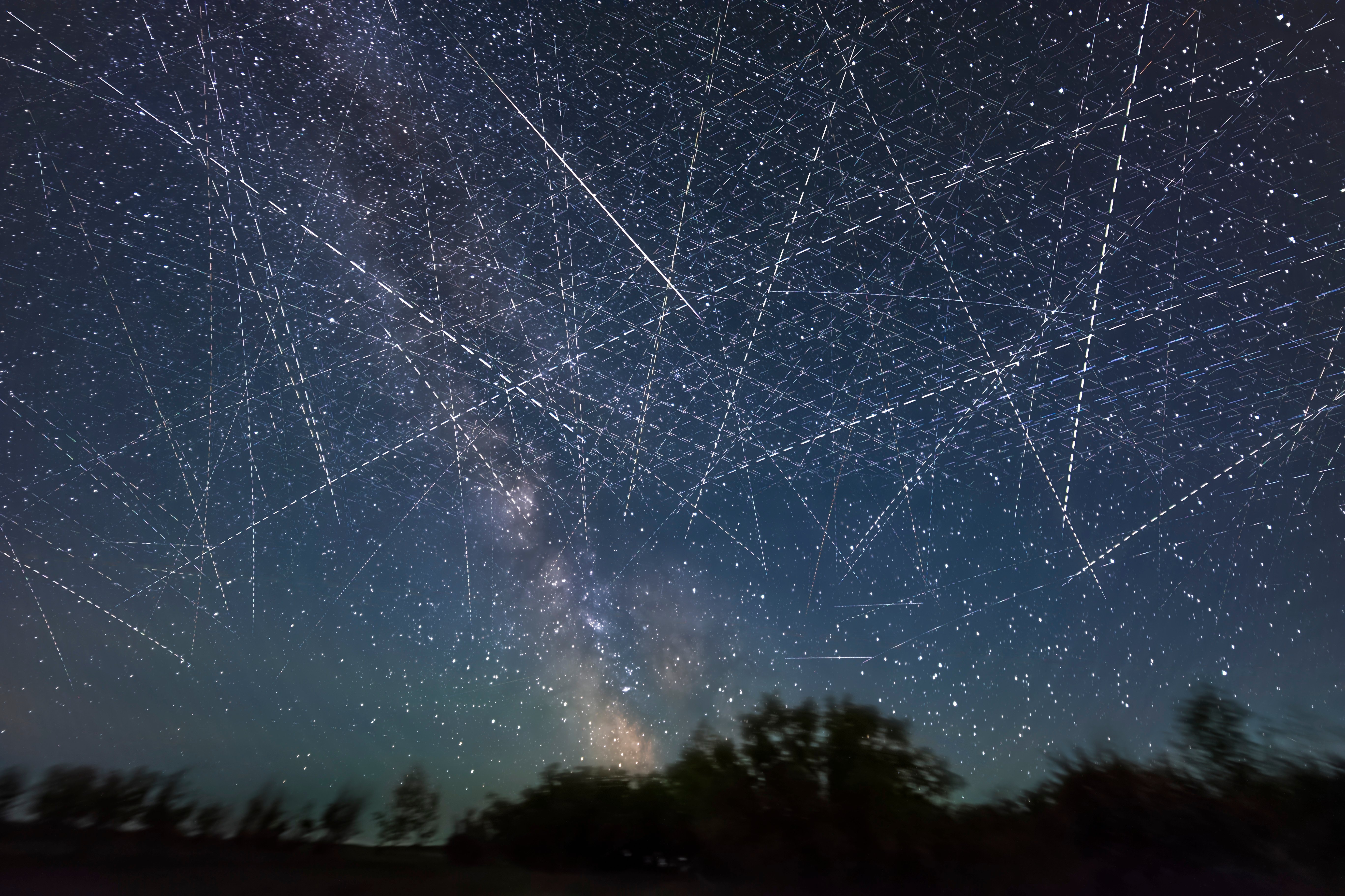 Long-exposure taken over 30 seconds showing many satellites moving across the night sky appearing as dotted lines.