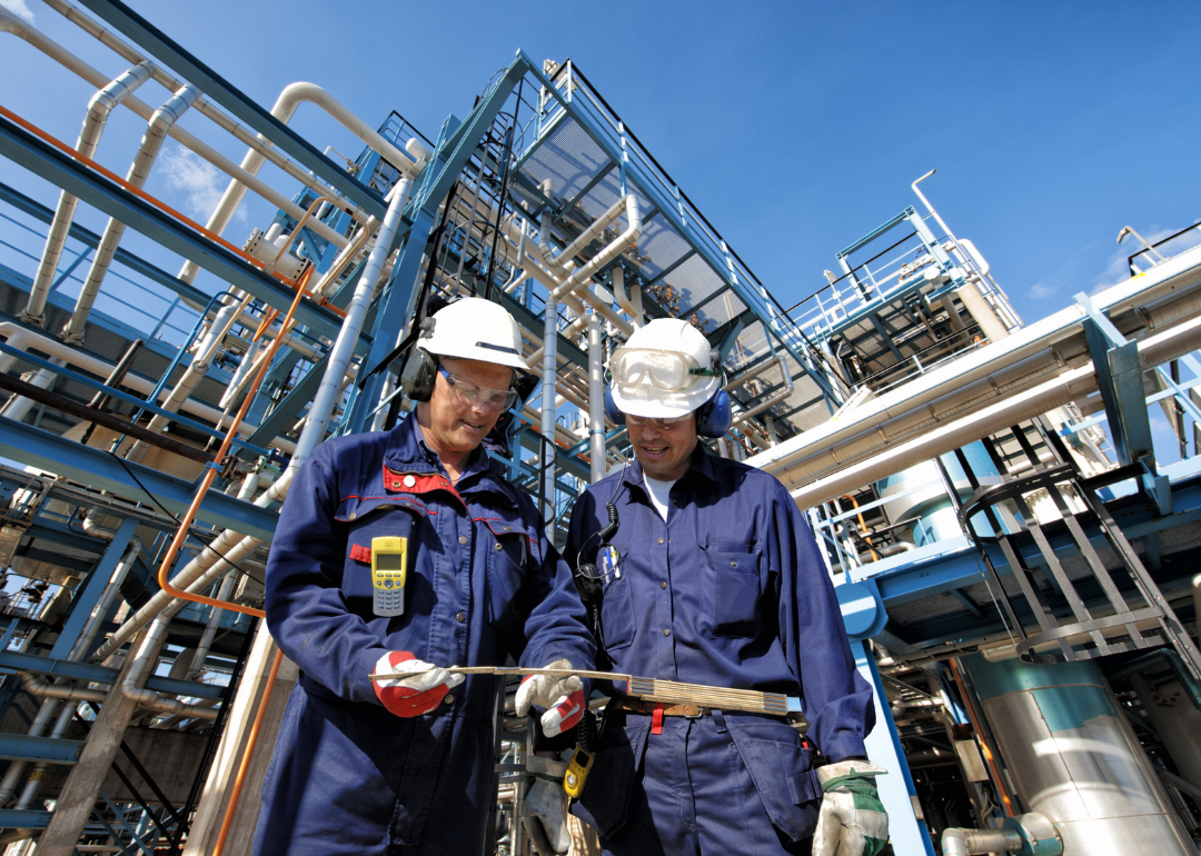Two workers at an oil refinery plant