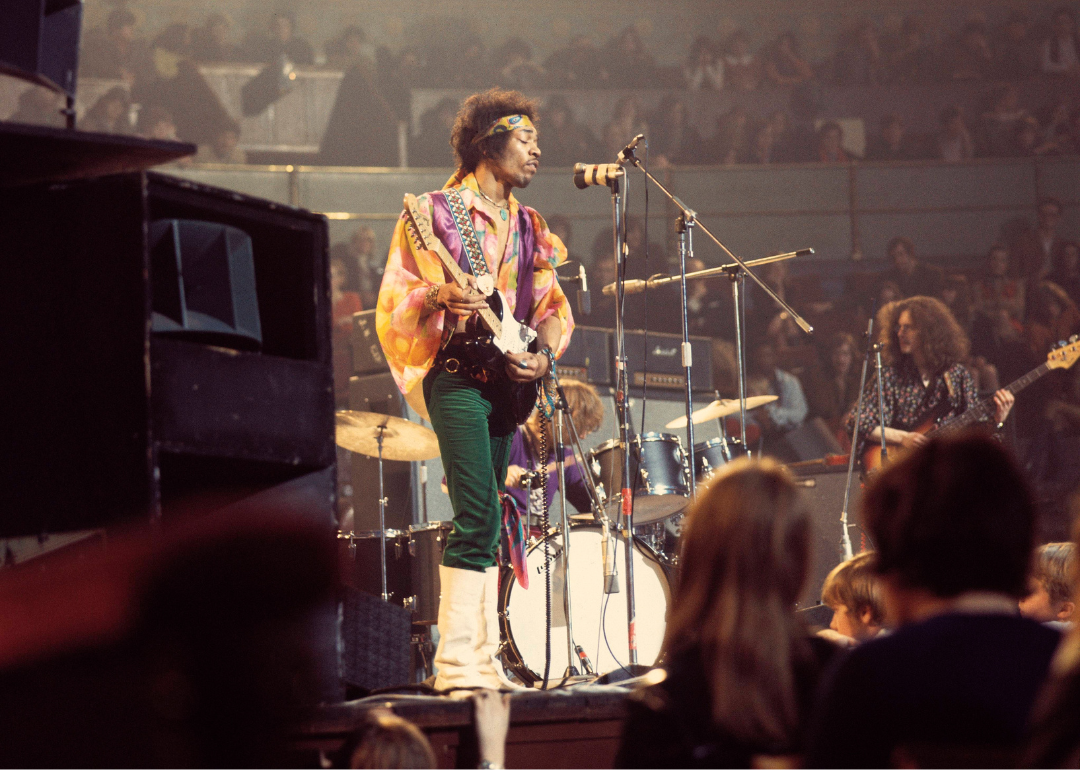 American rock guitarist and singer Jimi Hendrix (1942-1970) performs live on stage playing a black Fender Stratocaster guitar with drummer Mitch Mitchell and bassist Noel Redding of The Jimi Hendrix Experience at the Royal Albert Hall in London on 24th February 1969. 