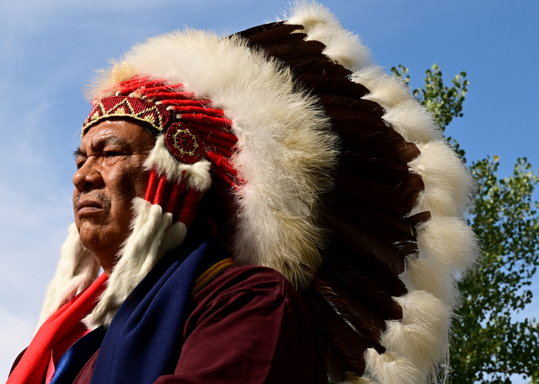 Northern Cheyenne tribal chief Anthony Spottedwolf listening to Cheyenne and Arapaho tribal members perform in a drum circle as they play a traditional flag and memorial song during a gathering at the Sand Creek Massacre National Historic site on October 5, 2022