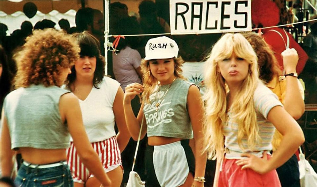 Four women hanging out at a festival