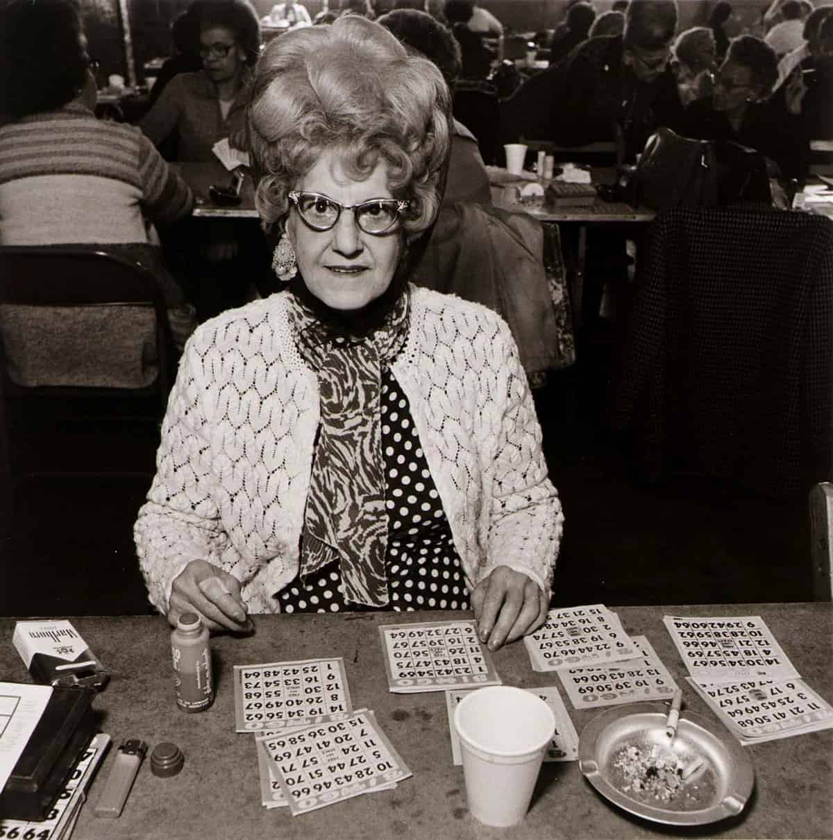 Woman dressed up with many bingo cards in front of her