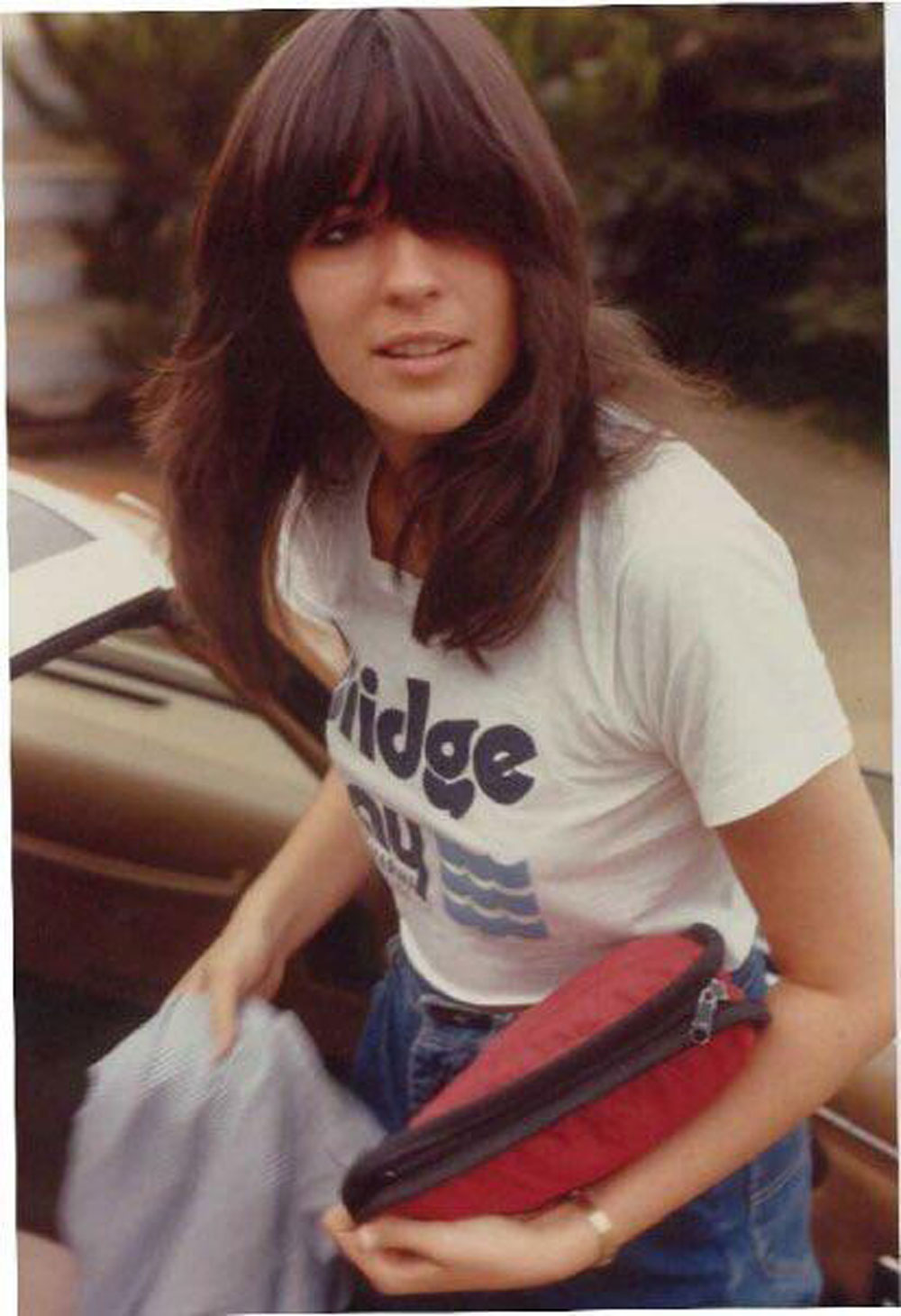 Woman with long hair and bangs in 1983