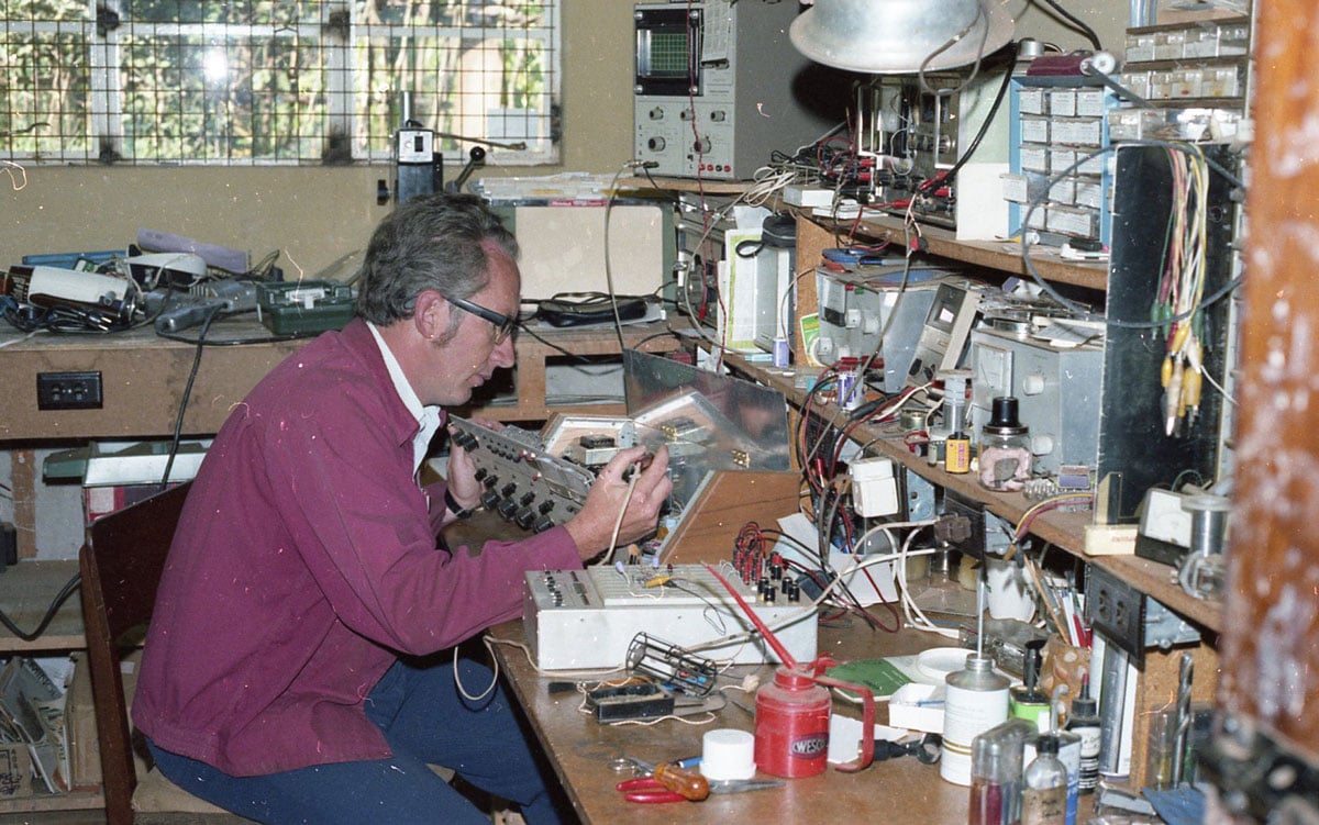 A man working on electronics at home