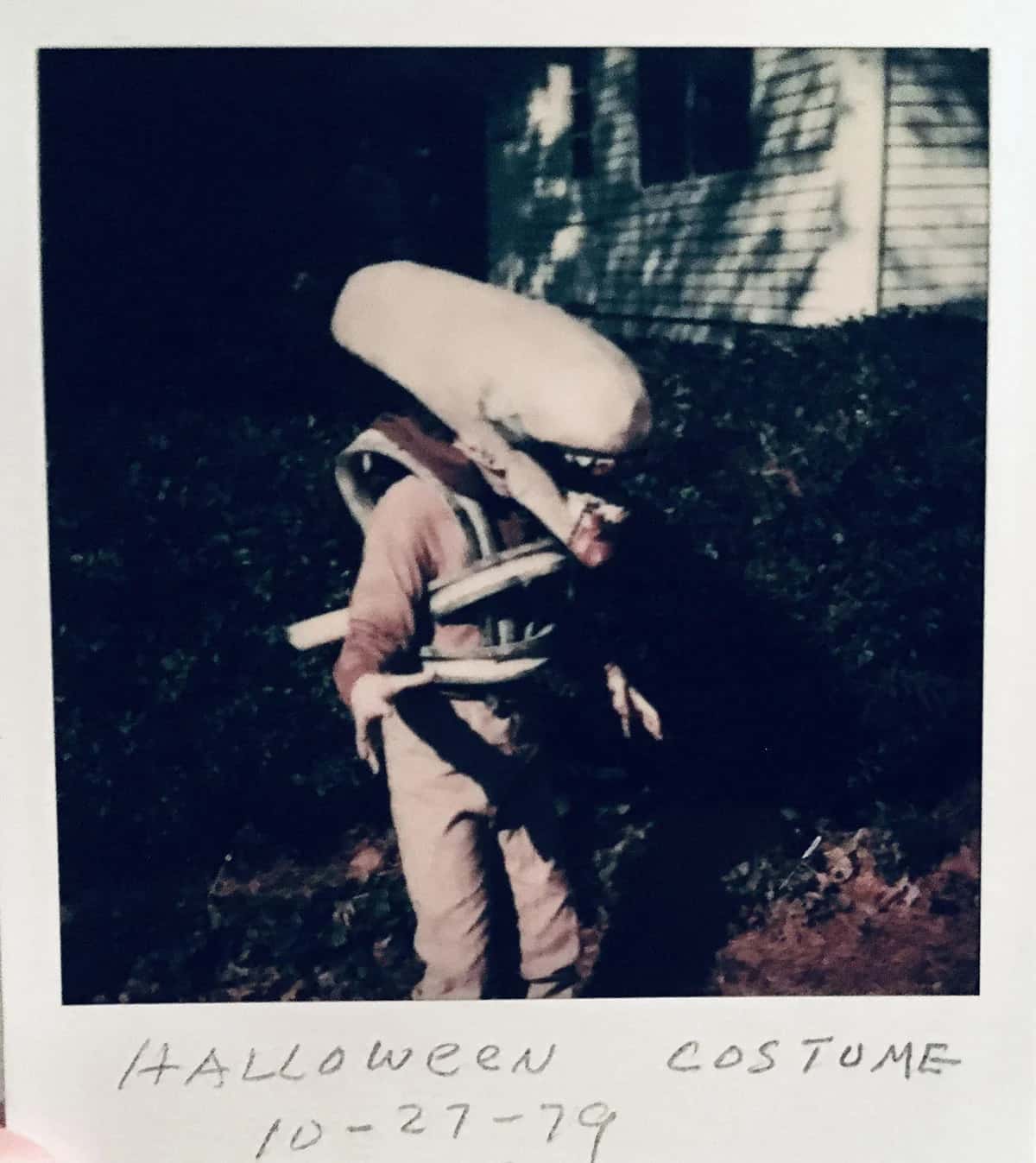 Polaroid of a kid wearing a homemade Alien costume with 'Halloween Costume 10-27-79' written in pencil on the bottom