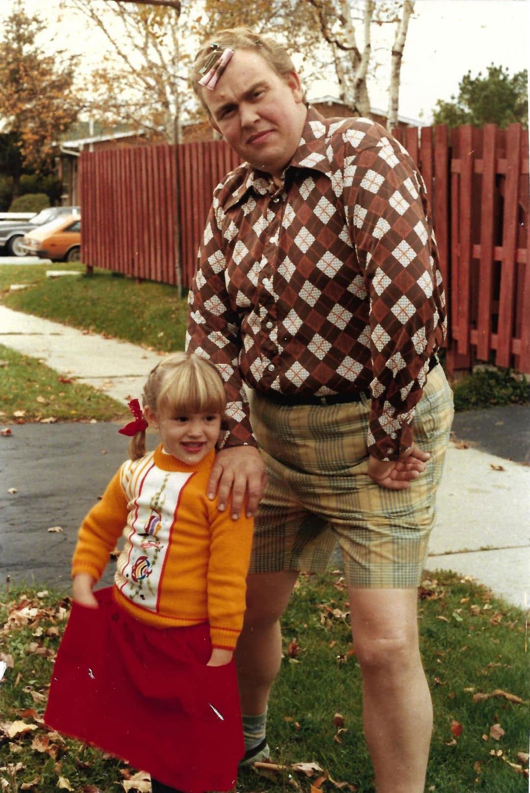 John Candy and his daughter standing in some grass