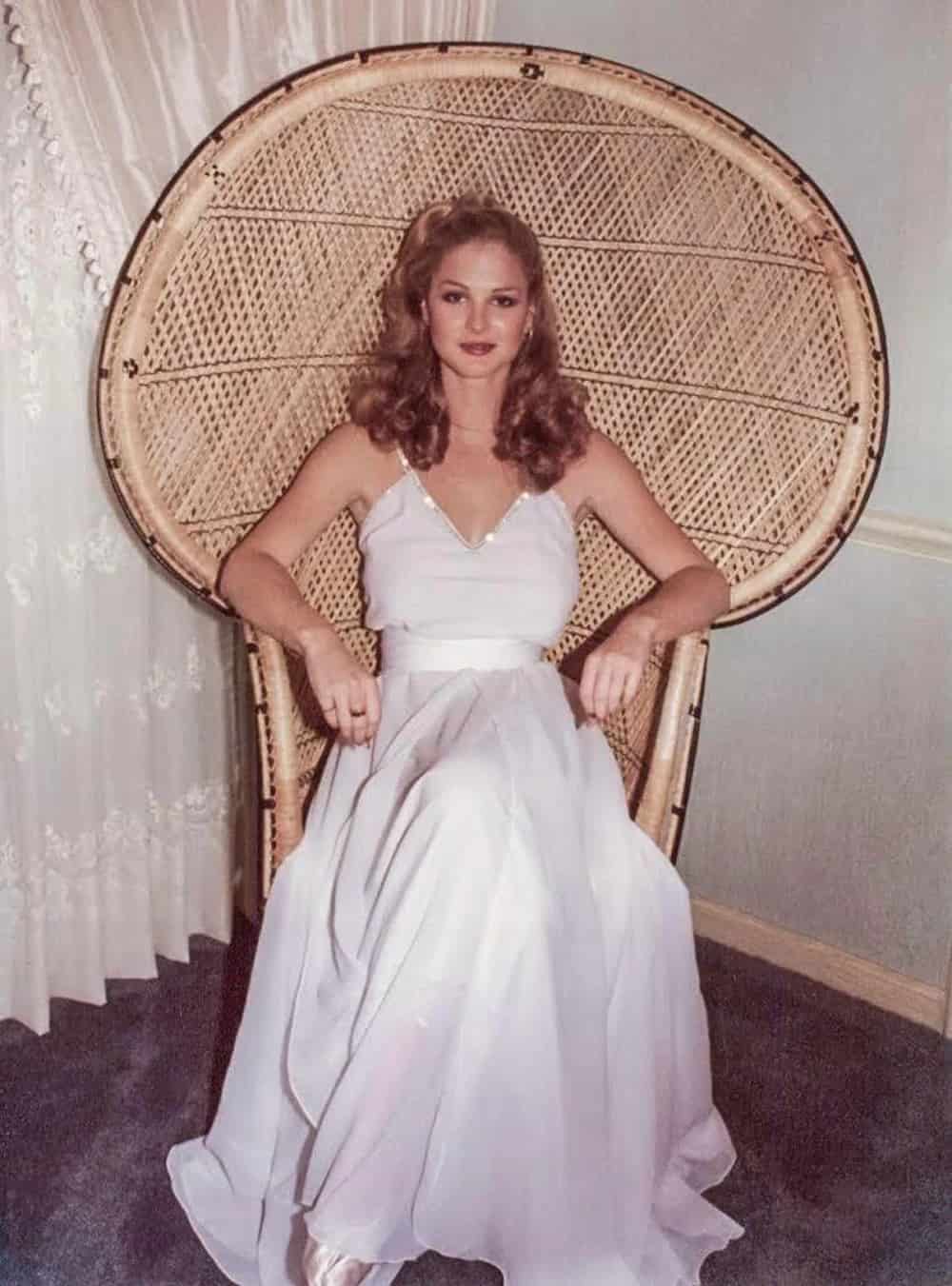 Woman in a wedding dress sitting in a chair