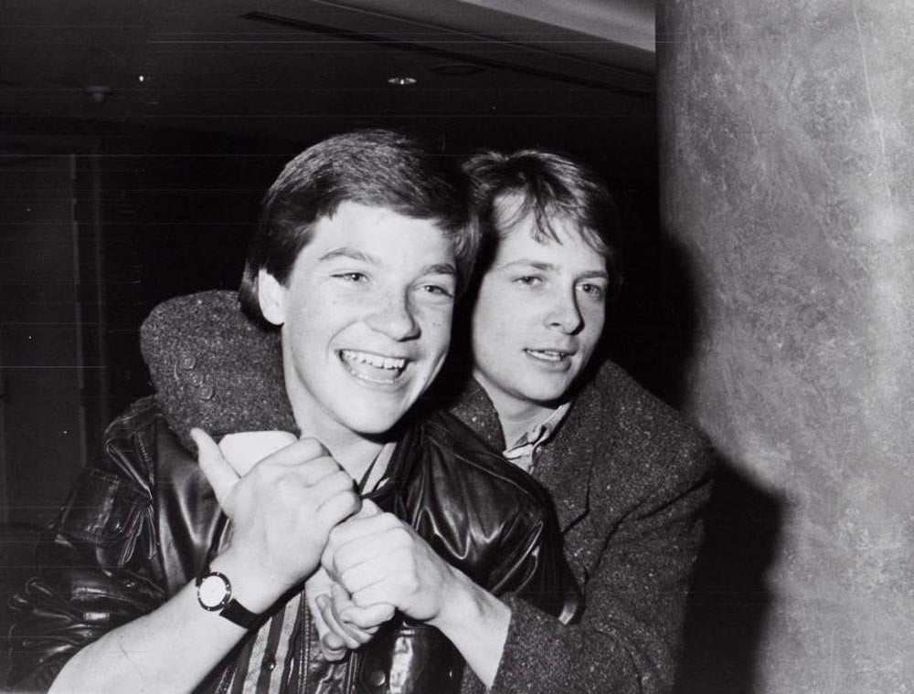 Black and white photo of Michael J. Fox with his arm around Jason Bateman when they were kids