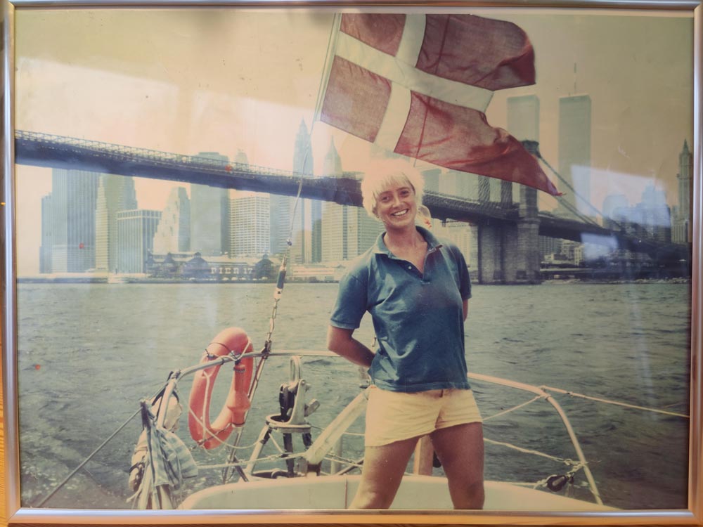 Woman smiling and proudly standing on her boy in the East River