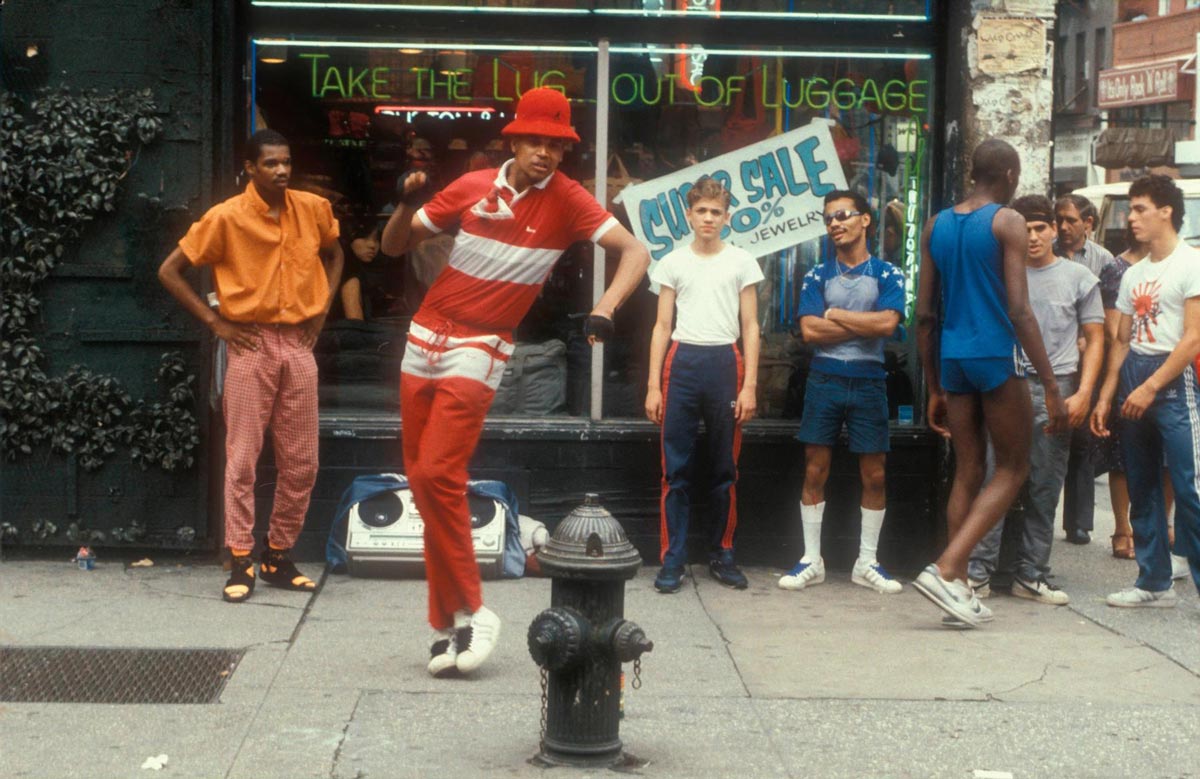 Photo of multiple young men hanging out on the street dancing