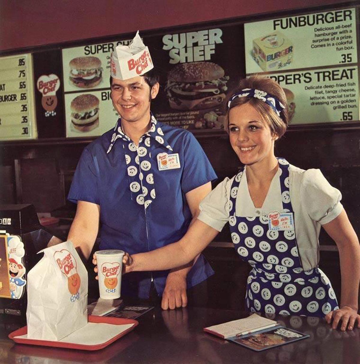 A young man and woman working at a Burger Chef in the 1970s